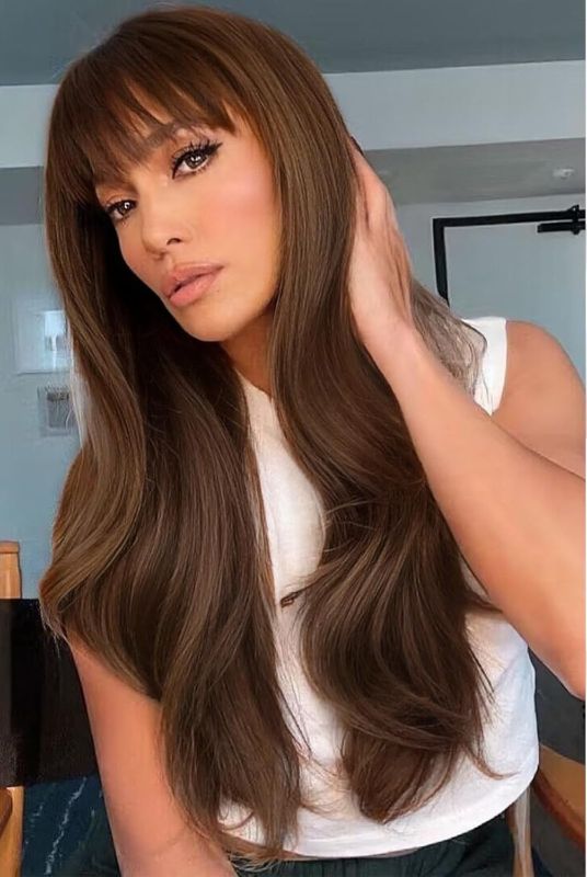 Photo 1 of MERISIHAIR Long Brown Wavy Wigs with Bangs for Women 26inch Brown Curly Wavy Wig Natural Looking Synthetic Heat Resistant Fiber Wig for Daily Party Use