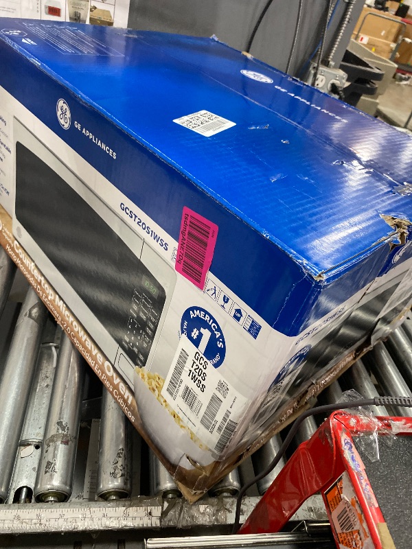 Photo 1 of (LARGE, PRE-OPENED*) BLACK+DECKER EM720CB7 Digital Microwave Oven with Turntable Push-Button Door, Child Safety Lock, 700W, Stainless Steel, 0.7 Cu.ft