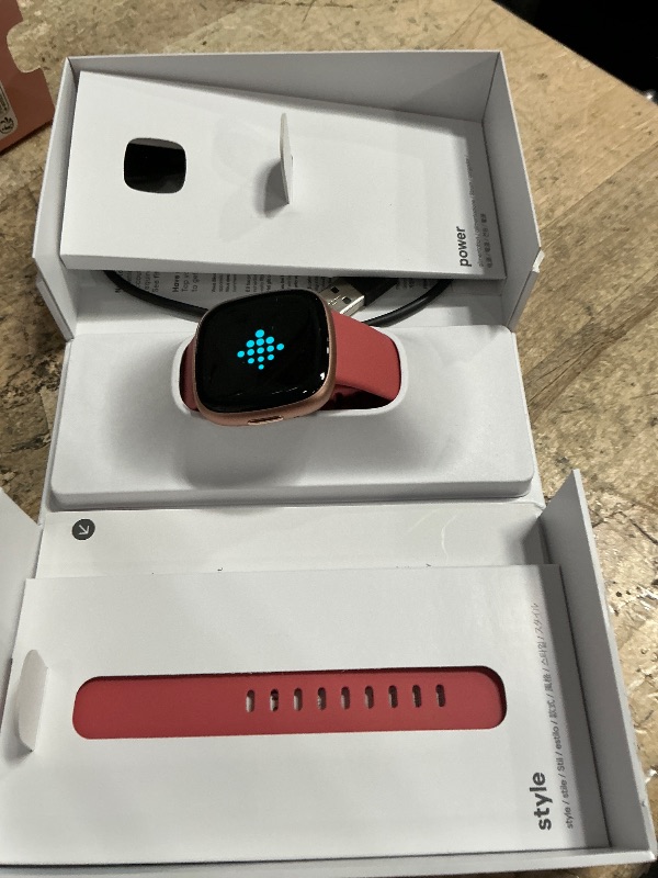Photo 1 of **ISSUES PAIRING WITH APP** Fitbit Versa 4 Fitness Smartwatch with Daily Readiness, GPS, 24/7 Heart Rate, 40+ Exercise Modes, Sleep Tracking and more, Pink Sand/Copper Rose, One Size (S & L Bands Included)