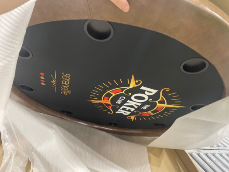 Photo 1 of ******************* The edge of the table is cut with a box opener******************
SereneLife 8- Player Round Foldable Poker Table, Casino Leisure Texas Holdem Table, w/ water Resistant Cushioned Rail, 8 Cup Holders, Brown Felt Surface, Black Jack Board