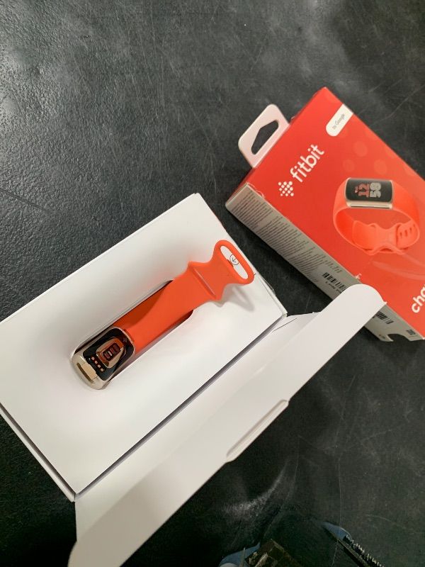 Photo 1 of Fitbit Charge 6 Fitness Tracker with Google apps, Heart Rate on Exercise Equipment, 6-Months Premium Membership Included, GPS, Health Tools and More, Gold/Coral, One Size (S & L Bands Included)