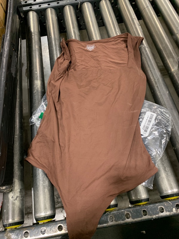 Photo 1 of BROWN SHIRT 
SIZE M 
