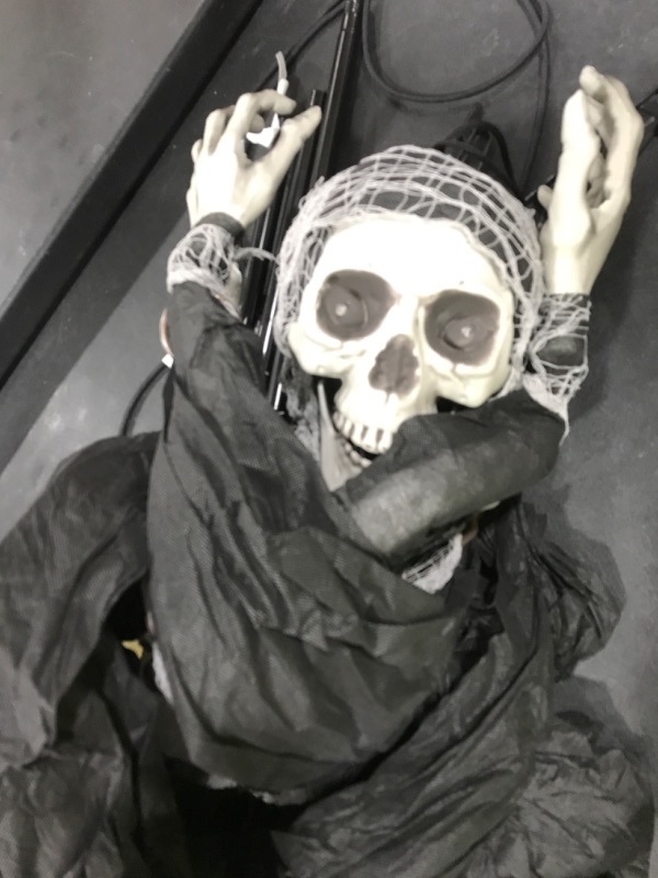 Photo 1 of Haunted Hill Farm Life-Size Scary Skeleton Reaper Holding Lantern, Halloween Animatronic with Touch Activated Lights and Sound, Battery Operated Indoor or Covered Outdoor Halloween Decorations