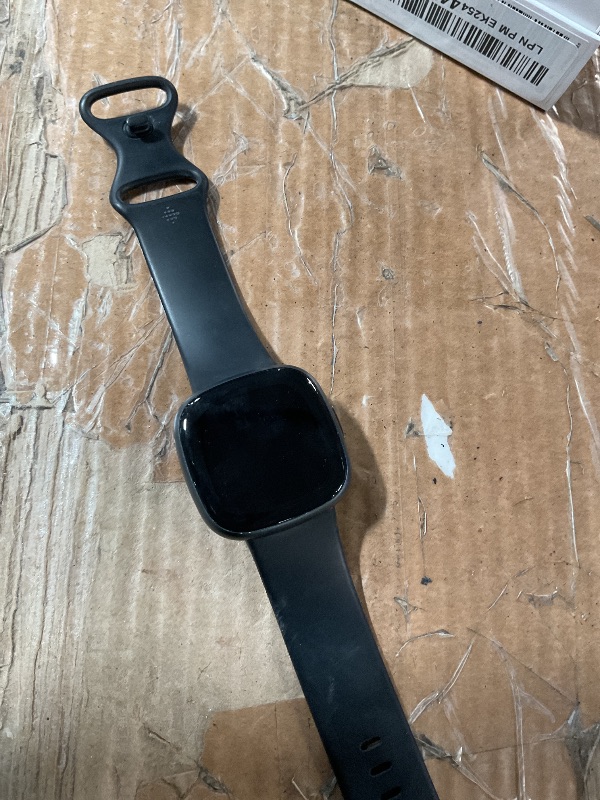 Photo 1 of ***(MAJOR DAMAGE/ SEE NOTES FOR DETAILS)***Fitbit Versa 4 Fitness Smartwatch with Daily Readiness, GPS, 24/7 Heart Rate, 40+ Exercise Modes, Sleep Tracking and more, Black/Graphite, One Size (S & L Bands Included)