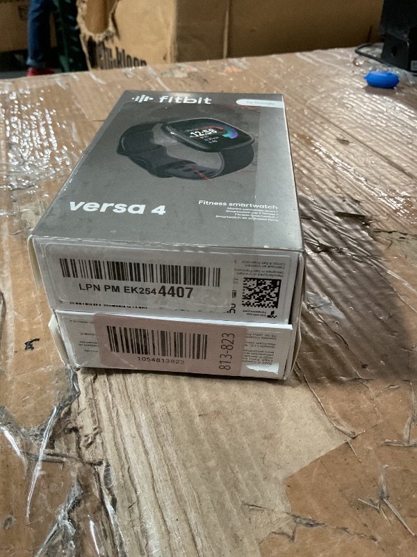 Photo 1 of ***(MAJOR DAMAGE/ SEE NOTES FOR DETAILS)***Fitbit Versa 4 Fitness Smartwatch with Daily Readiness, GPS, 24/7 Heart Rate, 40+ Exercise Modes, Sleep Tracking and more, Black/Graphite, One Size (S & L Bands Included)