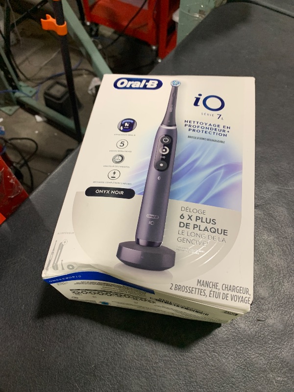 Photo 1 of Oral-B iO Deep Clean + Protect Rechargeable Electric Toothbrush, Black with a iO Series 7 Toothbrush, 2 Replacement Brush Heads, and a Charging Travel Case
