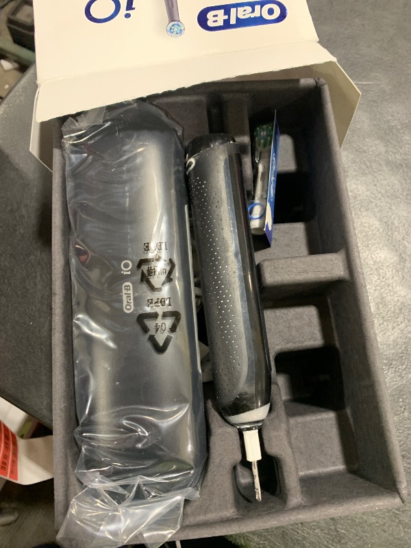 Photo 1 of Oral-B iO Deep Clean + Protect Rechargeable Electric Toothbrush, Black with a iO Series 7 Toothbrush, 2 Replacement Brush Heads, and a Charging Travel Case