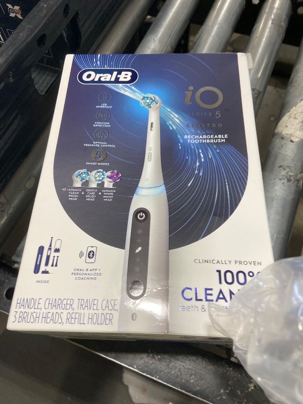 Photo 1 of Oral-B Rechargeable Electric Toothbrush, iO5 Limited Deep Clean & Whiten, 5 Cleaning Modes, Visual Pressure Sensor to Protect Gums, Travel Case, 3 Brush Heads, White