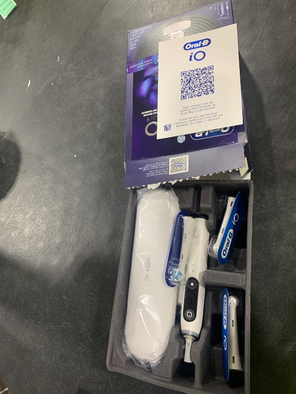 Photo 1 of Oral-B Rechargeable Electric Toothbrush, iO9 Genius, 7 Cleaning Modes, Interactive Display, Charging Travel Case, Visible Pressure Sensor, 4 Brush Heads, White Alabaster