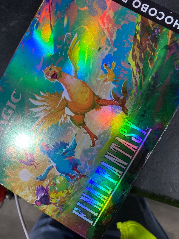 Photo 1 of Magic: The Gathering - Final Fantasy Chocobo Bundle (1 Chocobo Booster, 10 Play Boosters, 1 Alt-Art Promo Card, 1 Scene Card, 32 Basic Lands, 1 Click Wheel, and More)