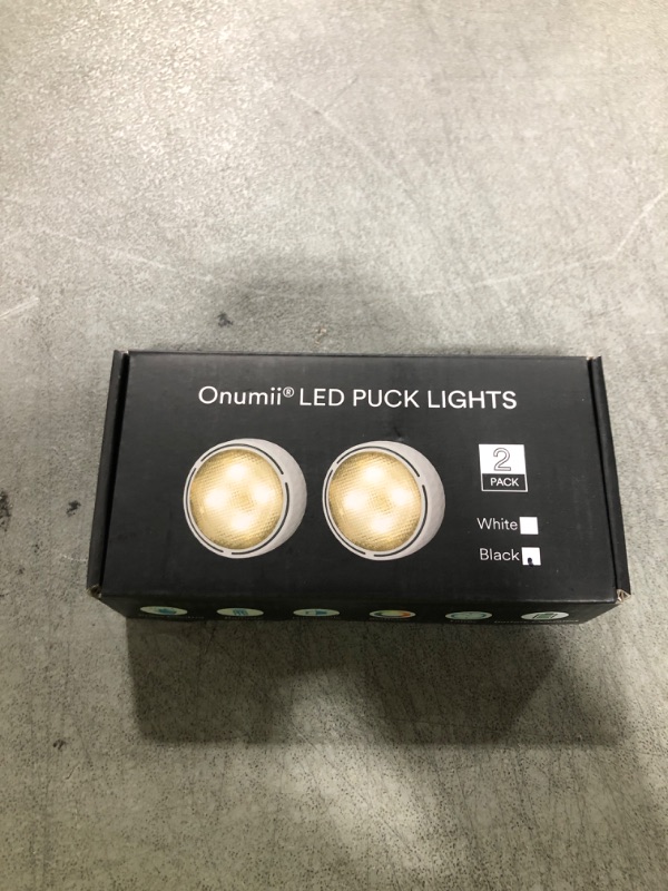 Photo 1 of Battery Operated Puck Lights with Remote LED Under Cabinet Lighting Wireless Stick on Lights Color Changing Timer Tap Lights for Cabinets Shelves Closets Display Case - 2Pack Black