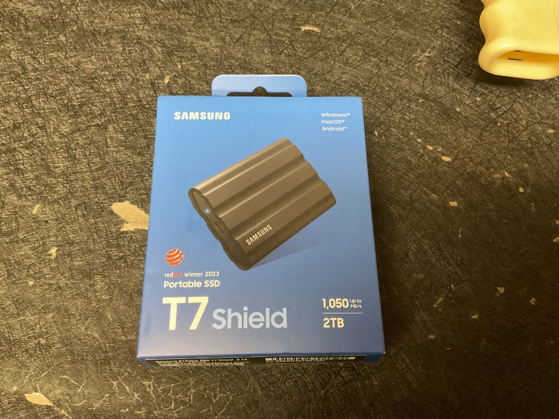 Photo 1 of Samsung T7 Shield 2TB, Portable SSD, up-to 1050MB/s, USB 3.2 Gen2, Rugged,IP65 Water & Dust Resistant, for Photographers, Content Creators and Gaming, Extenal Solid State Drive (MU-PE2T0S/AM), Black