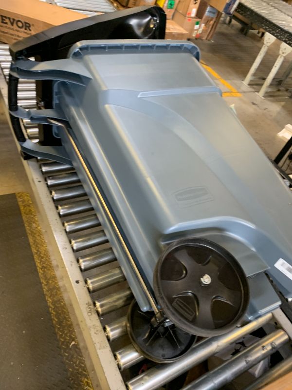 Photo 1 of **DENTED LID** Rubbermaid Commercial Products Brute Step-On Rollout Trash/Garbage Can/Bin with Wheels 32 GAL Gray for Restaurants/Hospitals/Back of House/Warehouses/Home