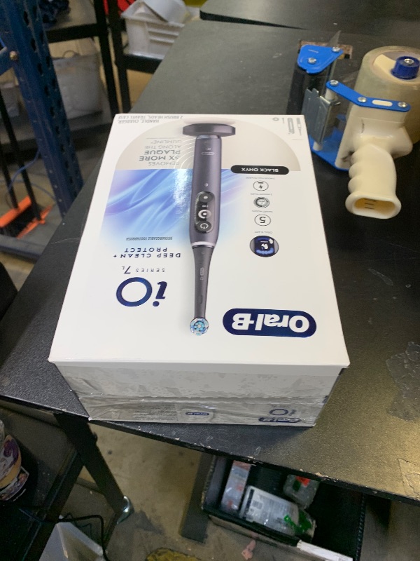 Photo 1 of Oral-B iO Deep Clean + Protect Rechargeable Electric Toothbrush, Black with a iO Series 7 Toothbrush, 2 Replacement Brush Heads, and a Charging Travel Case