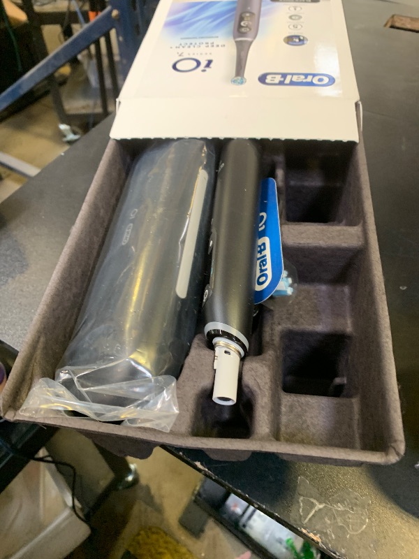 Photo 1 of Oral-B iO Deep Clean + Protect Rechargeable Electric Toothbrush, Black with a iO Series 7 Toothbrush, 2 Replacement Brush Heads, and a Charging Travel Case