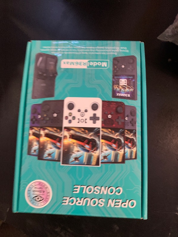 Photo 1 of ?R36MAX 4000mAh Portable Rechargeable Handheld Retro Game Console,Comfort Non-Slip Handheld Standing Retro Game Console with 64G TF Car,4.0-inch Screen,for Office,Black