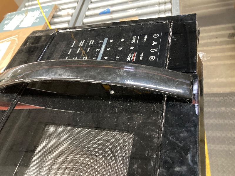 Photo 1 of ***BROKEN DOOR HANDLE/LARGE DENT ON TOP-SEE PICS***


BLACK+DECKER Over the Range Microwave Oven with Vent and One-Touch Auto Cooking, 1.7 cu. ft. OTR Over Stove Microwave, Black, 1000 Watts, EM044K6CF-BK