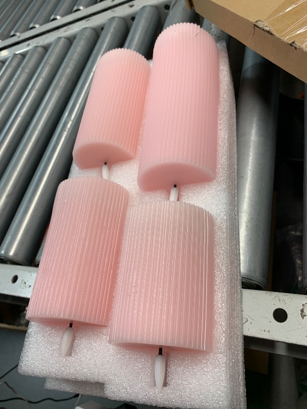 Photo 1 of (one is damaged) Girimax Pink Ribbed Flameless Pillar Candles with Remote, Flat Top Flickering LED Wax Battery Candles Set of 4