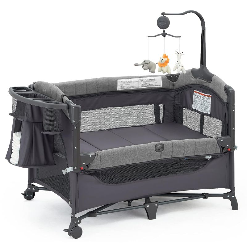 Photo 1 of Baby Bedside Bassinet Sleeper,5-in-1 Pack and Play with Full-Size Bassinet,Baby Playard with Changing Table,Storage Shelf,Music Mobile with Soft Toys for Newborn to Toddlers (Grey)
