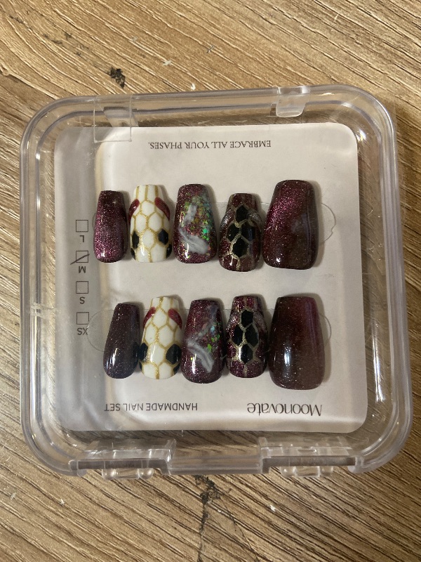 View 5 of Moonovate brand press-on nails featuring a gothic, burgundy red cat-eye design with snake skin and marbled accents