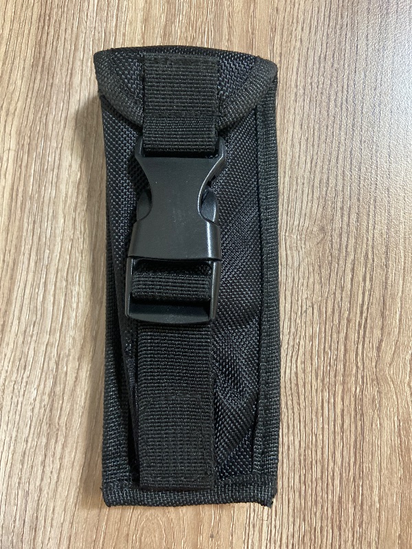 View 2 of Tactical black nylon pouch features a secure plastic buckle closure for carrying items like tools or accessories