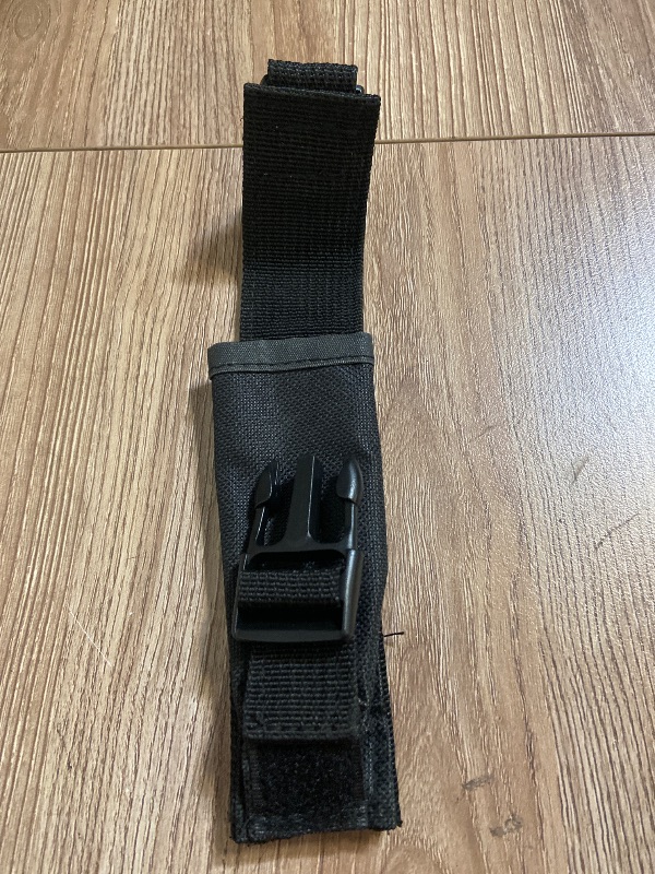 Photo 1 of *6in Black tactical nylon sheath featuring a plastic quick-release buckle and Velcro closures for securing a knife or tool