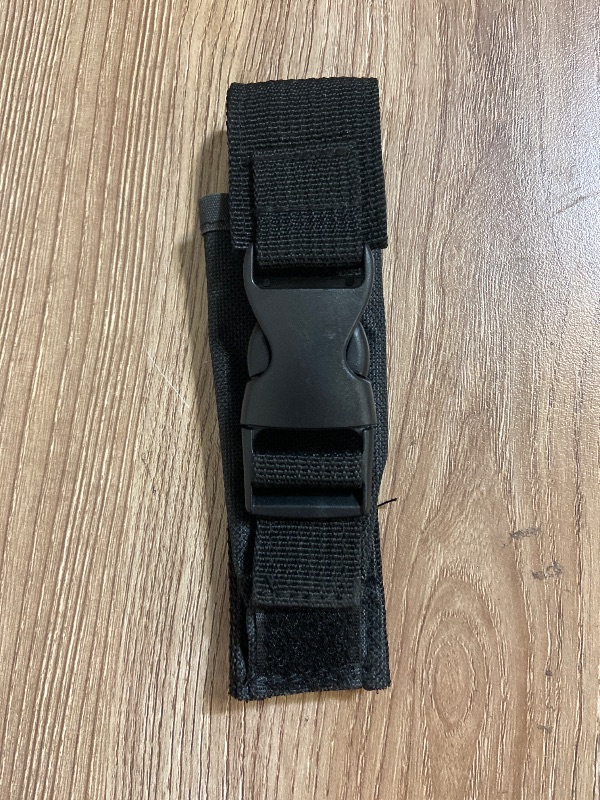Photo 1 of *6in Black tactical nylon sheath featuring a plastic quick-release buckle and Velcro closures for securing a knife or tool