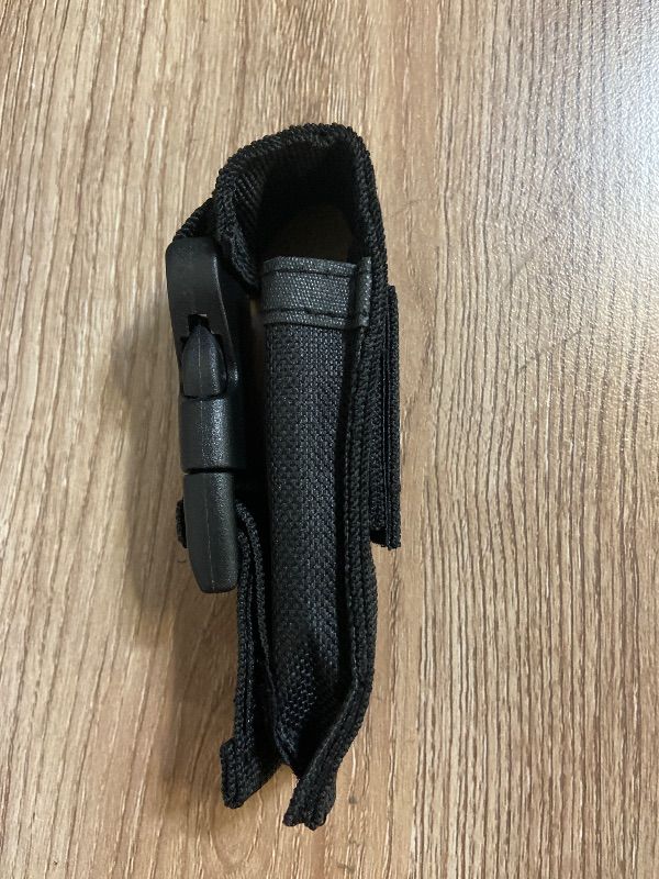 View 2 of *4.5in 2PK Black tactical pouch, often used as a sheath for Out-the-Front (OTF) automatic knives or similar tools.