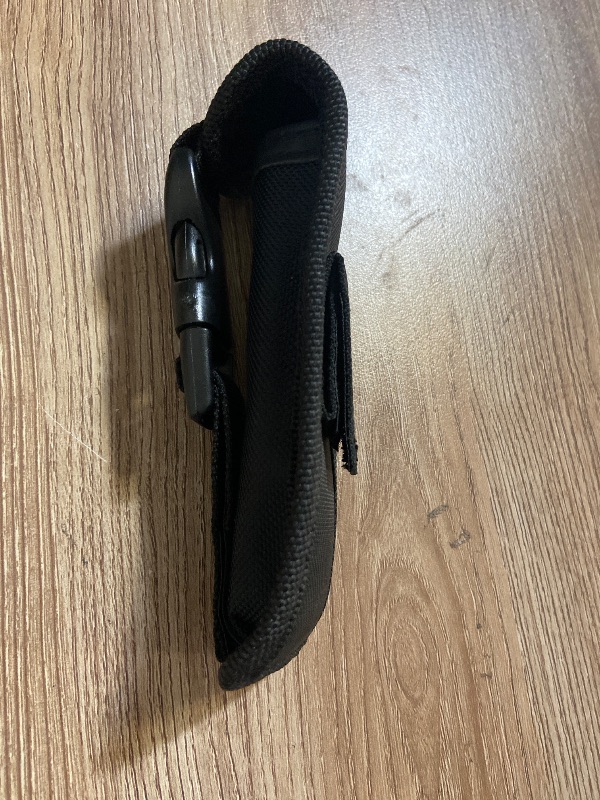Photo 1 of *5in black nylon tactical pouch features a quick-release plastic buckle for secure closure.