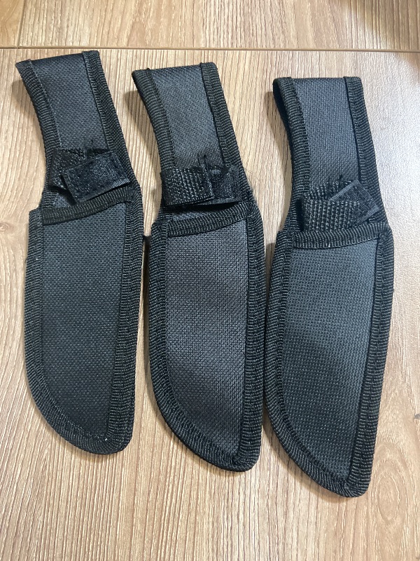 Photo 1 of 3pack black nylon sheaths are designed for holding tactical throwing knives and feature adjustable Velcro straps.