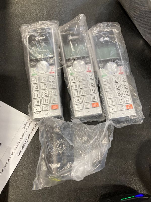 Photo 1 of AT&T CL84307 Dect 6.0 Expandable Corded/Cordless Phone with Smart Call Blocker, Silver/Black with 3 Handsets