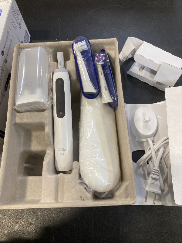Photo 1 of Oral-B iO Deep Clean + Whiten Rechargeable Electric Toothbrush with Visible Pressure Sensor, 2 Minute Timer, 5 Cleaning Settings, 1 iO5 Limited, 3 Toothbrush Heads, Travel Case & Refill Holder, White