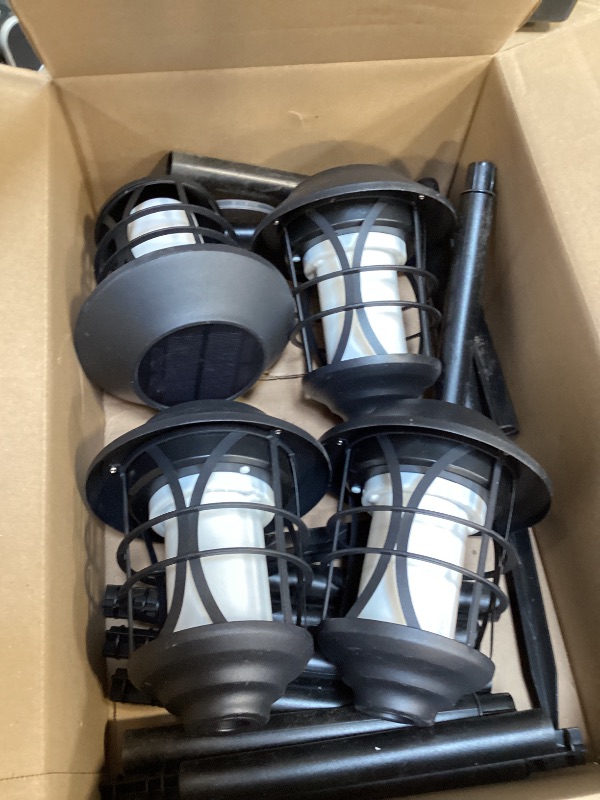 Photo 1 of TomCare Solar Outdoor Lights Metal Flickering Flame Torches Waterproof Heavy Duty Pathway Landscape Lighting Dusk to Dawn Auto On/Off for Garden Patio Yard, 4 Pack