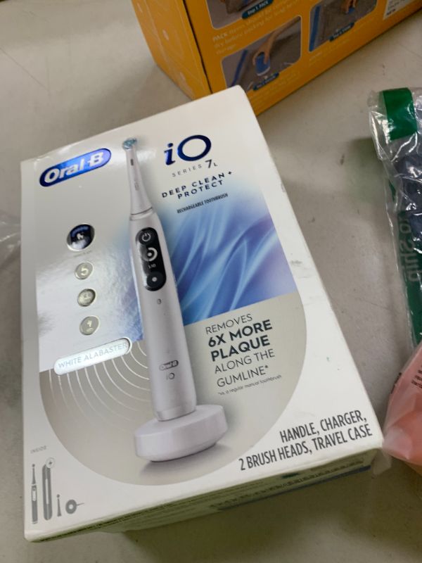 Photo 1 of Oral-B iO Deep Clean + Protect Rechargeable Electric Toothbrush, White with a iO Series 7 Toothbrush, 2 Replacement Brush Heads, and a Charging Travel Case