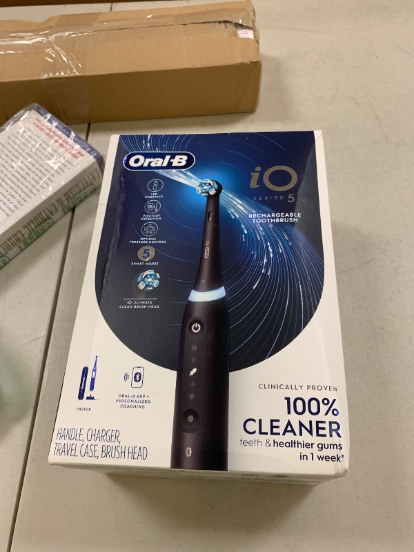 Photo 1 of Oral-B iO Series 5 Rechargeable Electric Toothbrush with Visible Pressure Sensor to Protect Gums, 2 Minute Timer, 5 Cleaning Settings, 1 Replacement Toothbrush Heads, and Travel Case, Black