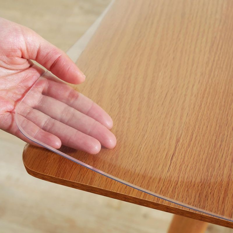 Photo 1 of Warmstar Clear Table Protector 2mm Thick, 40x66Inch Clear Table Cover Protector, Plastic Table Cover, Clear Desk Mat Desk Pad, Desk Protector Mat for Coffee Table, Writing Desk, Dining Room
