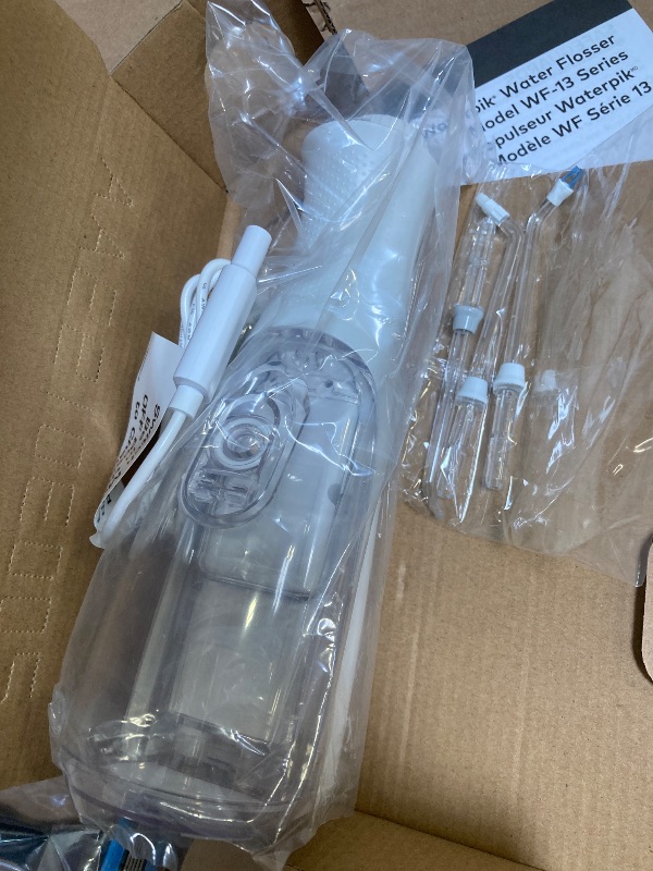 Photo 1 of Waterpik Cordless Pearl Rechargeable Portable Water Flosser for Teeth, Gums, Braces Care and Travel with 4 Flossing Tips - ADA Accepted, WF-13 White, Packaging May Vary