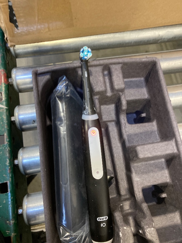 Photo 1 of Oral-B iO Deep Clean + Protect Rechargeable Electric Toothbrush, Black with a iO Series 7 Toothbrush, 2 Replacement Brush Heads, and a Charging Travel Case
