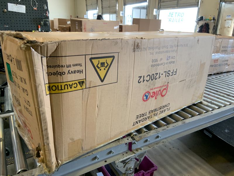 Photo 1 of Puleo International 12ft Pre-Lit Slim Fraser Fir Christmas Tree with 1200 Clear Lights, 3903 Realistic Dense Branch Tips, Easy Setup Artificial Trees with Sturdy Metal Stand