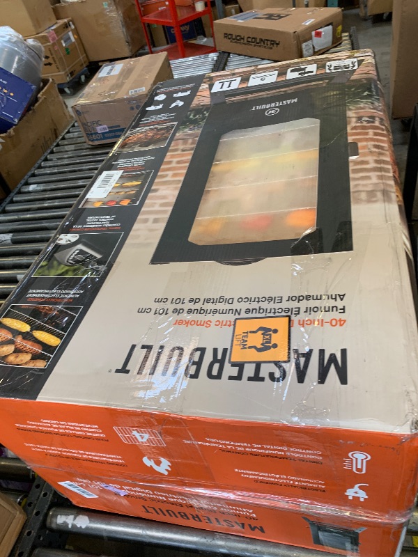 Photo 1 of Masterbuilt® 40-inch Digital Electric Vertical BBQ Smoker with Leg Kit, Side Wood Chip Loader and 970 Cooking Square Inches in Black, Model MB20070122