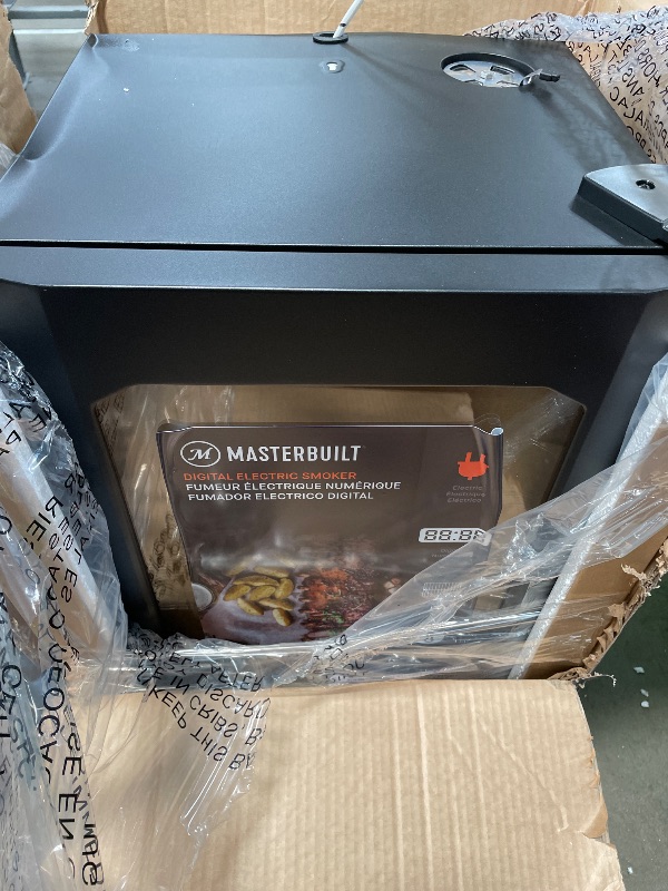 Photo 1 of (see images for damage) Masterbuilt® 30-inch Digital Electric Vertical BBQ Smoker with Leg Kit, Side Wood Chip Loader and 710 Cooking Square Inches in Black, Model MB20070421