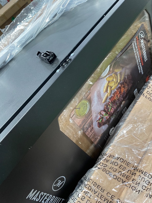 Photo 1 of (minor damage) Masterbuilt® 30-inch Digital Electric Vertical BBQ Smoker with Leg Kit, Side Wood Chip Loader and 710 Cooking Square Inches in Black, Model MB20070421