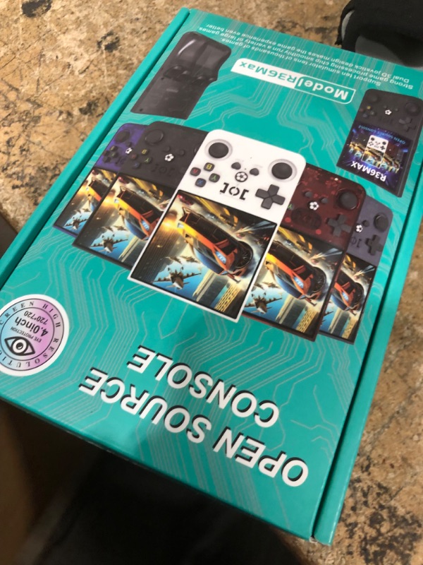 Photo 1 of **CRACKED SCREEN** R36MAX Retro Handheld Game Console - 64GB Preloaded Classic Video Games, Support 30+ Simulators, Linux-Powered Portable Game Emulator Console with 4.0-in HD IPS Screen (Transparent Red)