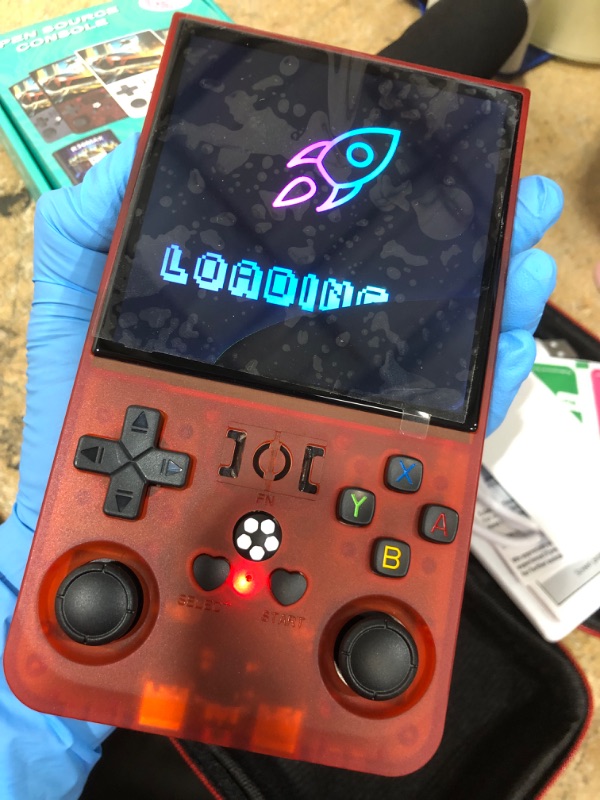 Photo 1 of **CRACKED SCREEN** R36MAX Retro Handheld Game Console - 64GB Preloaded Classic Video Games, Support 30+ Simulators, Linux-Powered Portable Game Emulator Console with 4.0-in HD IPS Screen (Transparent Red)