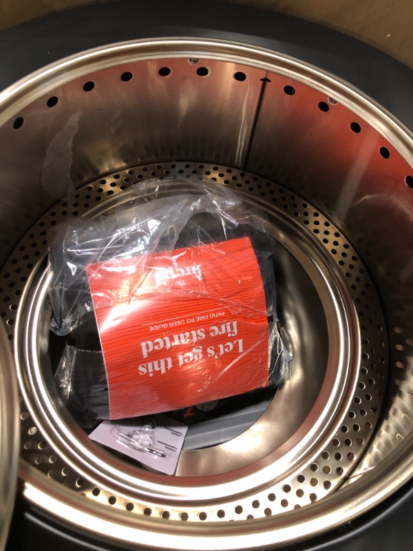 Photo 1 of ****BEATEN AND BENT ON ONE SIDE, AS SHOWN IN THE IMAGE****TIKI Patio Fire Pit Bundle – 25-Inch Smokeless Wood Burning Outdoor Fire Pit for Backyard, Patio, Deck & Garden with Removable Ash Pan, Stand & Weather-Resistant Cover – Modern Black Stainless Stee