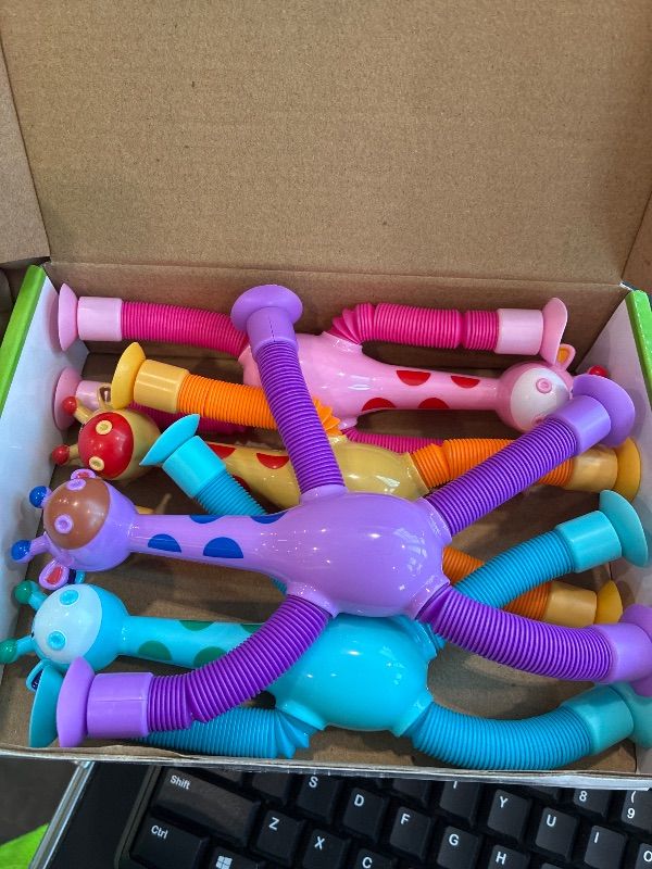 Photo 1 of **MINOR DAMAGE - USED**
XONTEUS 4Pcs Giraffe Pop Tubes Sensory Toys, Telescopic Suction Fidget Toys for Autism, Toddler Travel & Airplane Activities, 2025 Boy & Girl Christmas Stocking Stuffers Gift Idea