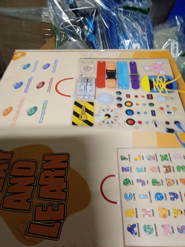 Photo 1 of 23 in 1 Busy Board Montessori Toys for 1-3 Year Old Wooden Learning Educational Toy for Toddlers with 15 Switches, 26 LED Lights, Music Boxes, Locks,Zippers Toddler Sensory Toys for Soothing A Baby