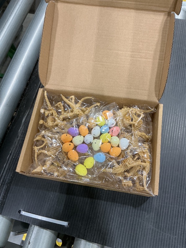 Photo 1 of 24 Pcs Dinosaur Fossil Skeleton Dino Bones Sand Dig Colorful Foam Dinosaur Eggs and 4 White Plastic Bones Toys for Kids Science Play Dino Sand Halloween Party Decor Supplies(Light Brown)