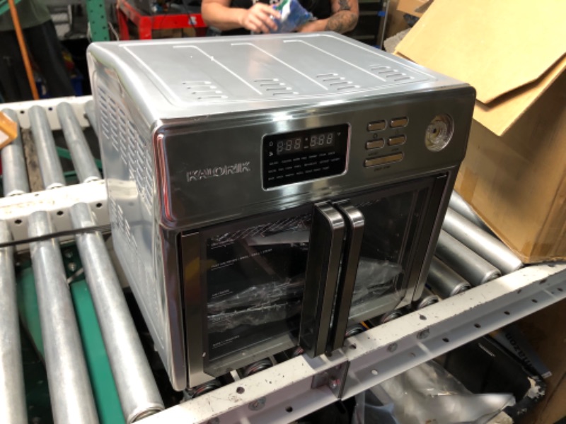Photo 1 of ***DAMAGED - CORNER CAVED IN - KNOB BROKEN OFF - SEE PICTURES***
Kalorik MAXX Air Fryer Oven, 26 Quart 10-in-1 Countertop Toaster Oven & Air Fryer Combo - Fry, Bake, Roast, Rotisserie, & More, Large Glass French Doors & 9 Accessories, 1700-Watts, Stainles