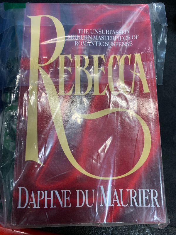 Photo 1 of "Rebecca" by Daphne du Maurier is a gothic novel that follows an unnamed young woman who marries the wealthy widower Maxim de Winter and moves to his grand estate, Manderley. However, she struggles to escape the shadow of Maxim’s first wife, Rebecca, whos